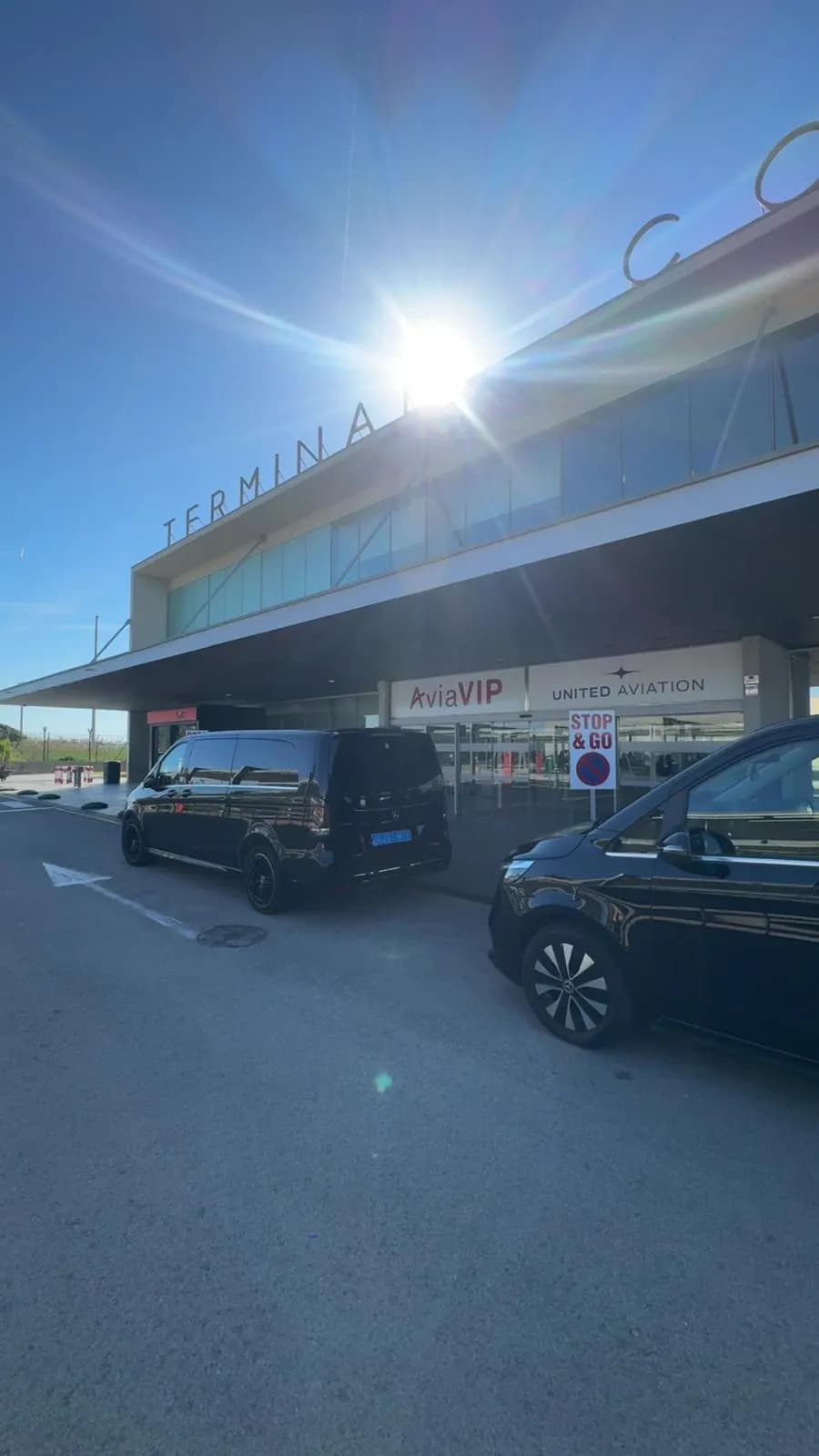 Two AurelTransfers Mercedes V-Class vans at a private aviation VIP terminal