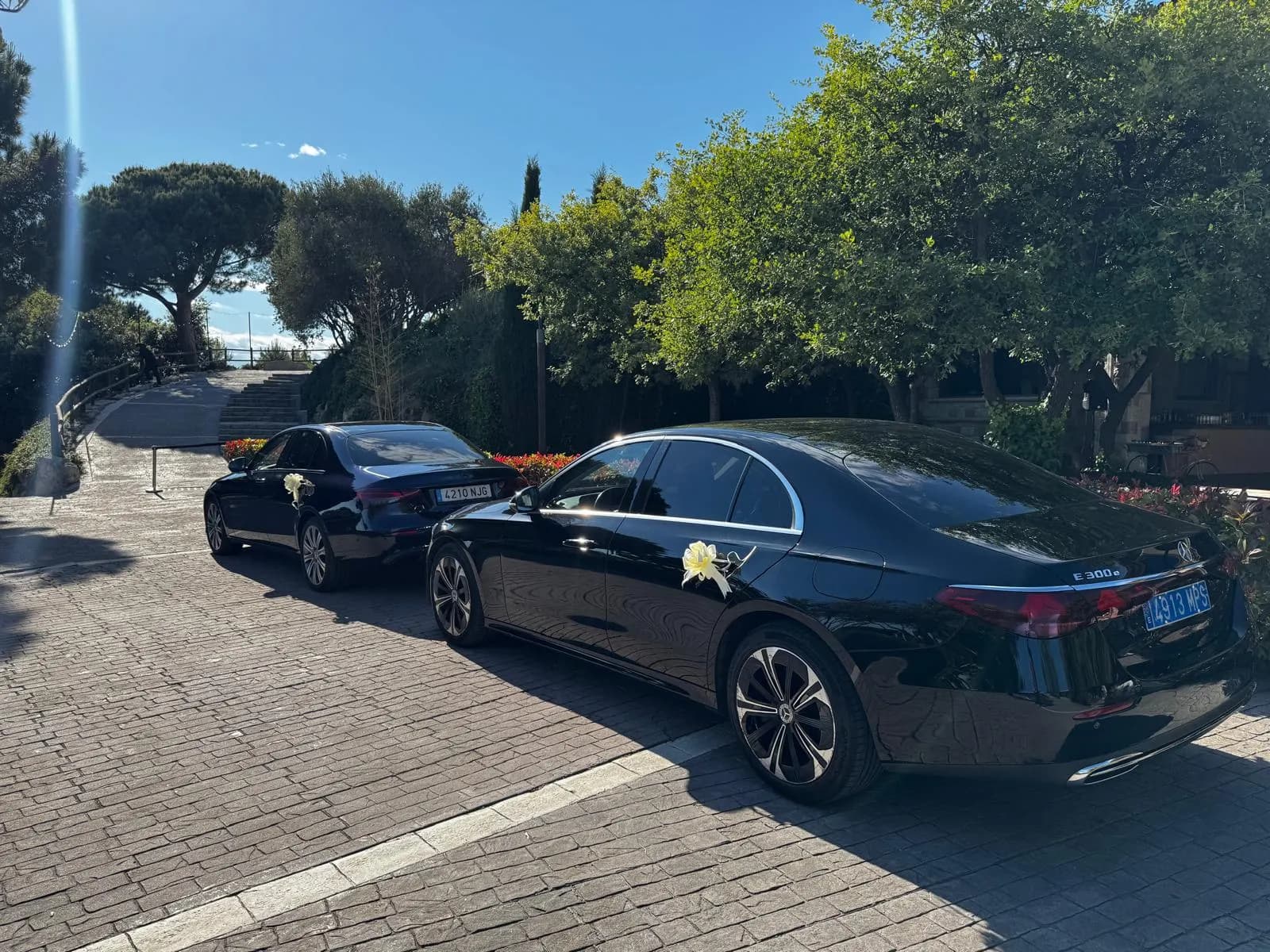 Two Mercedes E-Class wedding cars at a venue driveway near Barcelona